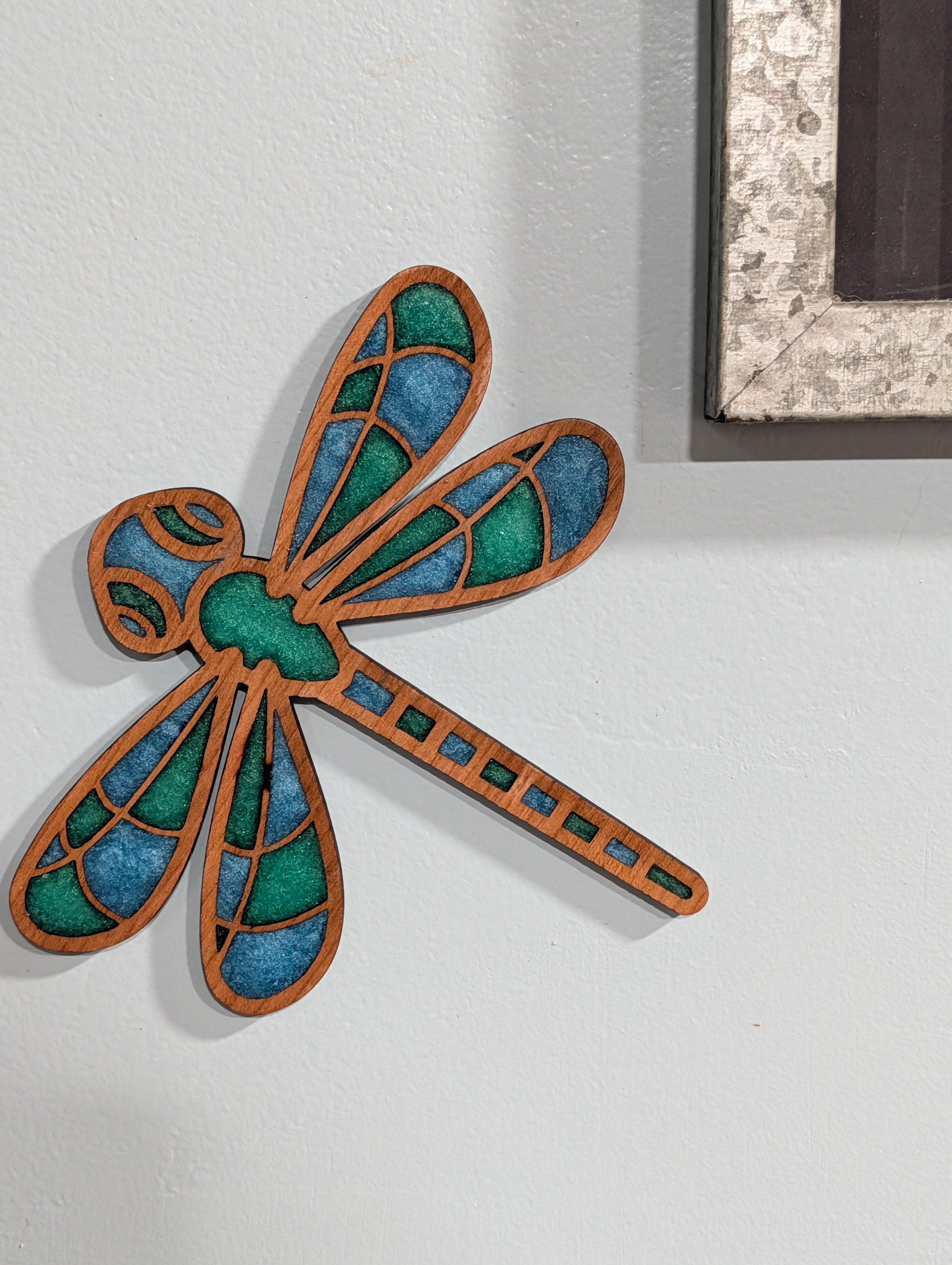 Colourful Dragonfly Decoration - A wooden frame with blue and green resin infill